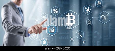 Man clicks on a virtual screen bitcoin icon. Stock Photo