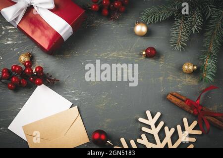 Greeting letter, envelope and feather surrounded by Christmas decorations Stock Photo