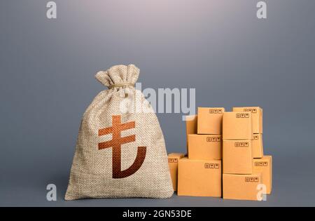 Boxes and turkish lira money bag. The concept of trade in goods and production. Profit from trading. GDP economy. Import export. Warehousing logistics Stock Photo