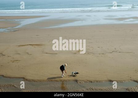 Lady walking her dog, North Bay Beach, Scarborough, UK. Stock Photo