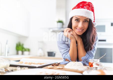 Lovely woman smiling widely after a full day of christmas baking. Stock Photo