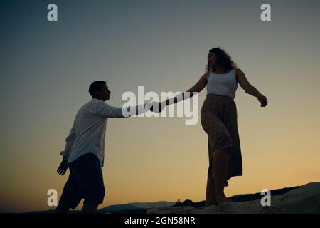 Man and woman holding hands Stock Photo