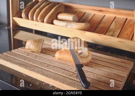 Bread loafs at wooden cutting board Stock Photo
