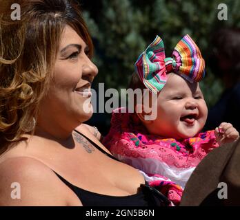 A woman talks with friends while holding her young daughter at the annual Fiesta de Santa Fe in Santa Fe, New Mexico. Stock Photo
