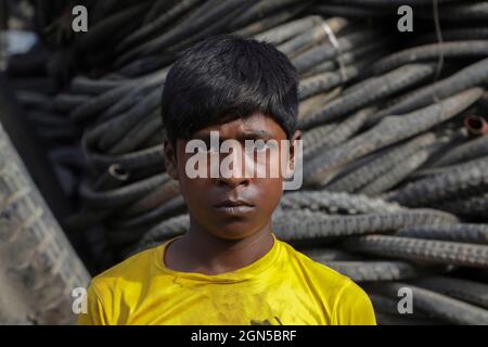 Dhaka, Bangladesh. 22nd Sep, 2021. A child worker Md Nahid 12 Years Old seen sorting for recycle at Tyre recycling scram yard in Dhaka City. Credit: SOPA Images Limited/Alamy Live News Stock Photo