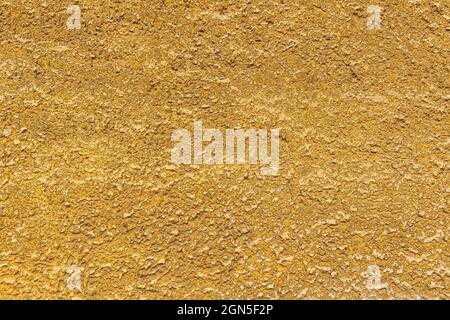 Sandy yellow, bumpy surface, plaster with abrasions Stock Photo