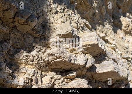 White layered cliff rocks texture, geology close-up, coast of Lefkada island in Greece. Summer wild nature material surface close-up Stock Photo
