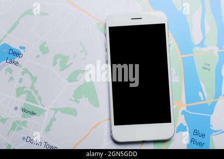 Modern mobile phone on city map Stock Photo