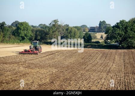A farmer ploughing fields near Atherstone, Warwickshire on the first day of Autumn. Stock Photo