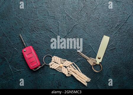 Keys with keychains on dark background Stock Photo