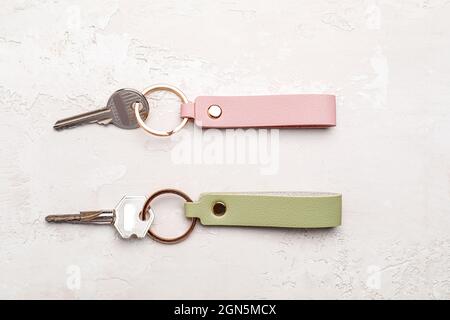 Keys with leather keychains on light background Stock Photo