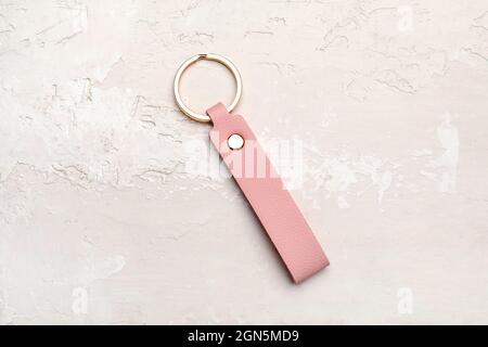 Leather keychain on light background Stock Photo