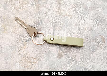 Key with leather keychain on light background Stock Photo