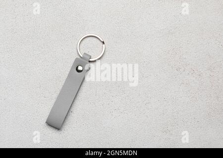 Leather keychain on light background Stock Photo