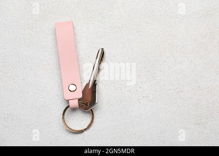 Key with leather keychain on light background Stock Photo
