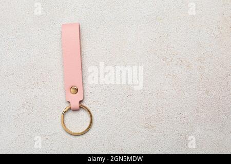 Leather keychain on light background Stock Photo