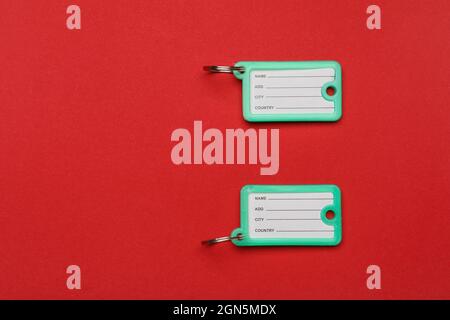 Plastic key tags on color background Stock Photo