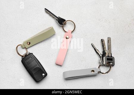 Keys with leather keychains on light background Stock Photo