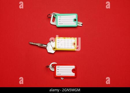 Keys with plastic tags on color background Stock Photo