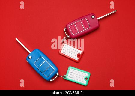 Car keys with plastic tags on color background Stock Photo