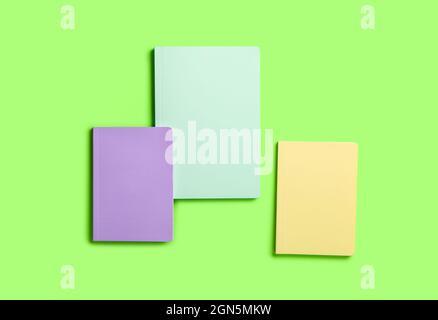 Different notebooks on color background Stock Photo