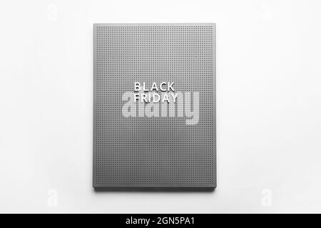 Board with text BLACK FRIDAY on light background Stock Photo