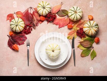 Stylish table setting and autumn decor on color background Stock Photo