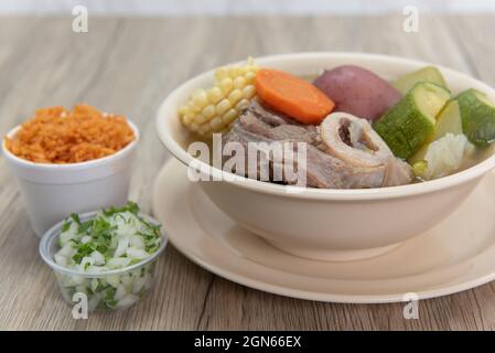 Hearty bowl of Caldo de res Mexican beef stew hot from the stove and served with rice and pico de gallo. Stock Photo