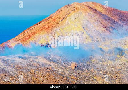 People walking through fumaroles on Volcano Gran crater rim, Vulcano Island, Aeolian Islands, UNESCO World Heritage Site, Sicily, Italy, Mediterranean Stock Photo