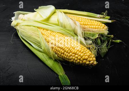 Fresh raw corns set, on black background Stock Photo