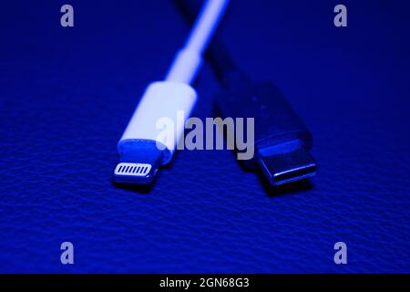 22 September 2021, Lower Saxony, Oldenburg: An Apple Lightning charging plug (l) is seen next to a USB-C charging plug. EU Commission presents proposal for unified mobile phone charging jack. The issue of chargers has preoccupied the EU institutions for more than a decade. In 2009, under pressure from the EU Commission, 14 mobile phone manufacturers - including Apple - agreed on a uniform standard for power sockets in a voluntary commitment. When it comes to the jacks in smartphones and tablet computers, three types remain from what were once several dozen: the now obsolete Micro-USB, the newe Stock Photo