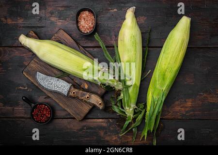 Fresh raw corns set, on old dark wooden table background, top view flat lay Stock Photo