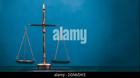 Golden brass balance or imbalance scale on blue color background. Weight  balance. Symbol of law justice, libra, decision, crime, financial Stock  Photo - Alamy