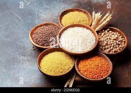 Gluten free cereals. Rice, buckwheat, corn groats, quinoa and millet in wooden bowls Stock Photo