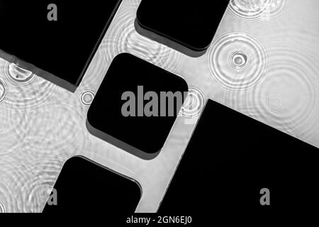 Abstract black geometric figures composition on transparent clear water Stock Photo