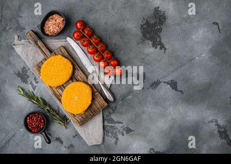 Frozen Breaded fish patties set, on black dark stone table background ...