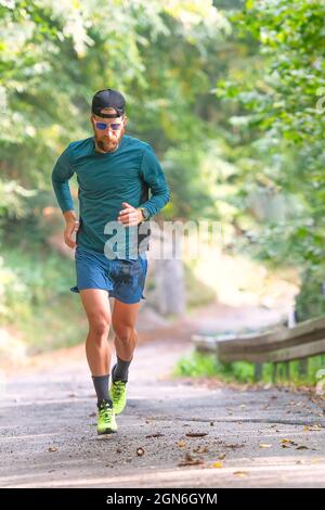 Uphill running on a small hillside road Stock Photo