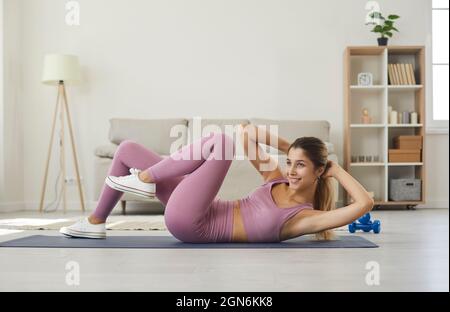 Young athletic woman doing cross training crunches to activate muscle and abs training. Stock Photo