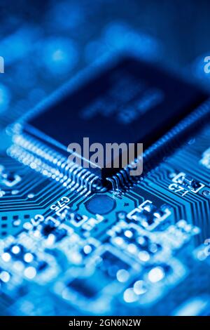Detail of a computer circuit board in blue light Stock Photo