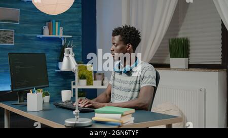 Programmer using software with data codes for firewall security on computer. Man working as coder programming binary code using cybersecurity interface for website. Person with coding app Stock Photo