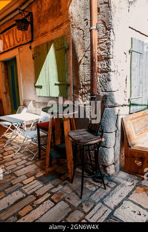 ROVINJ, CROATIA-AUGUST 30, 2018: an old table and chair on the street of the centuries-old historical center of the old town of Rovinj. Rovinj is a po Stock Photo