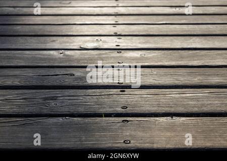 Background old gray Wooden Floor Made of Planks and Deep Holes Stock Photo