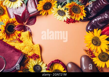 Autumn sale. Fall female fashion in orange yellow red colors with flowers. Set of clothes shoes accessories. Copy space. Stock Photo