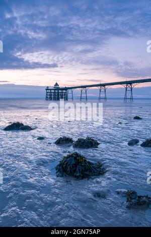 Clevedon Pier in the Severn Estuary at low tide after sunset, North Somerset, England. Stock Photo