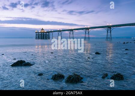 Clevedon Pier in the Severn Estuary at low tide after sunset, North Somerset, England.