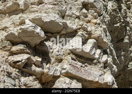 White layered cliff sharp rocks texture, geology close-up, coast of Lefkada island in Greece. Summer wild nature material surface close-up Stock Photo