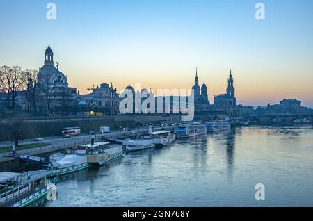 Dresden, Saxony, Germany: View from Carola Bridge to the historic Old Town riverfront at Terrassenufer in the twilight of the evening. Stock Photo