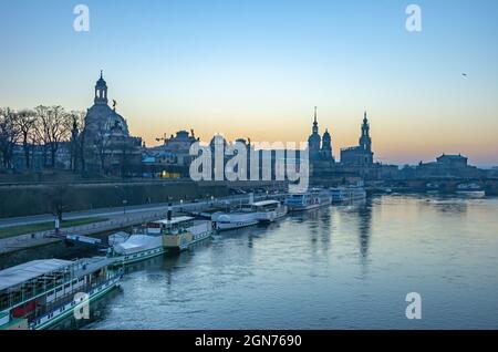 Dresden, Saxony, Germany: View from Carola Bridge to the historic Old Town riverfront at Terrassenufer in the twilight of the evening. Stock Photo