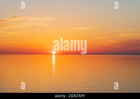 Sun going down at sunset over a calm sea