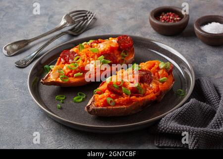 twice baked sweet potato with cheese and chorizo sausage Stock Photo